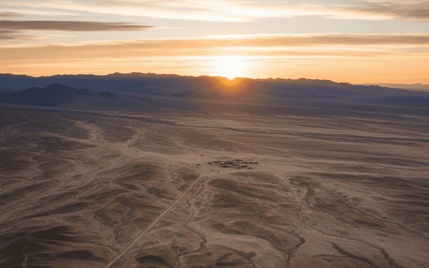 Sunrise over a wide desert valley